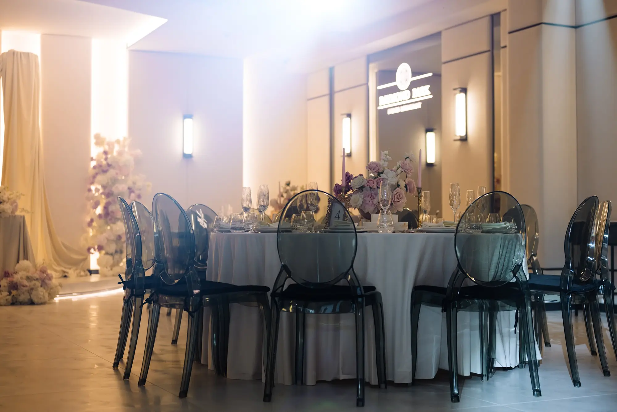 Sala Noir sub candelabrul rotund de cristal, cu mese rotunde și scaune transparente